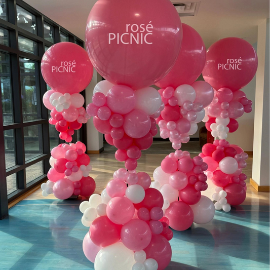Custom pink balloon sculptures with branded jumbo balloons for a corporate event activation at rosé PICNIC in Toronto