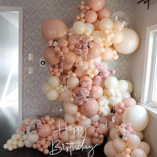 Elegant pink and cream, ivory balloon garland with florals for a luxury birthday celebration in Toronto adn the GTA