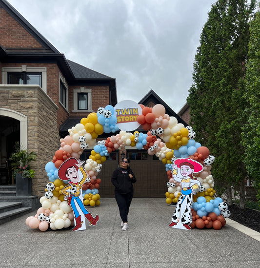 Grand double organic balloon arch installation for a luxury 'Twin Story' themed event in King City by WeBalloonz, featuring two layered arches