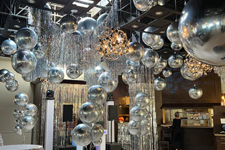Large-scale professional balloon installation featuring silver chrome spheres and tinsel for a corporate event venue in Toronto.