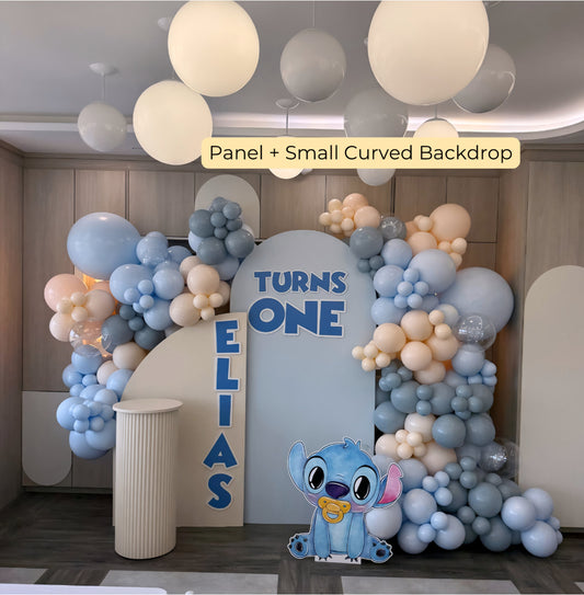 Baby Stitch-themed balloon backdrop with custom name and pastel garland for Eliasβ first birthday celebration.
