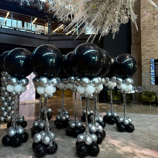 ustom balloon column for corporate events—featuring chrome, white, and black balloons with optional tassels. Perfect for branded decor in Toronto