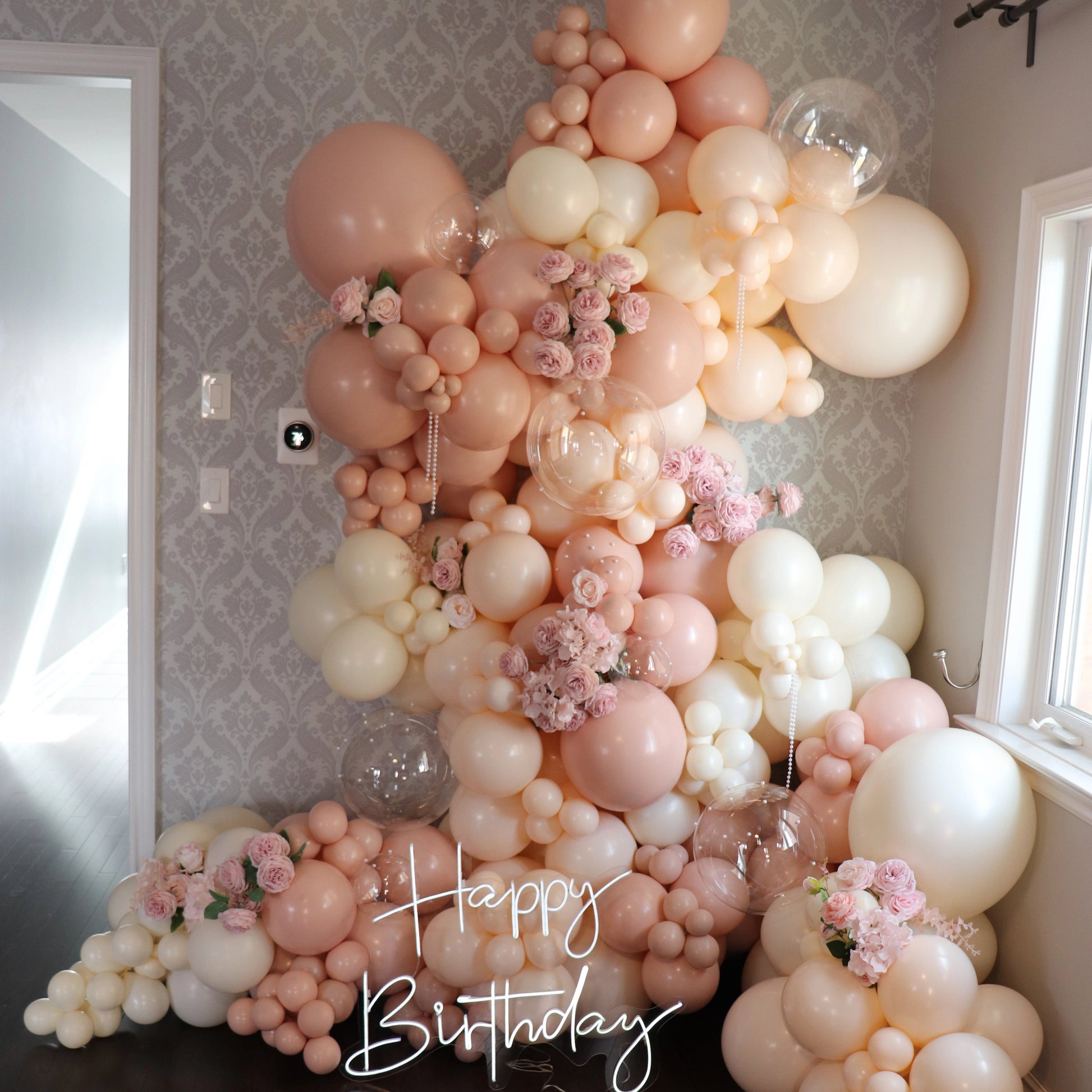 Elegant pink and cream, ivory balloon garland with florals for a luxury birthday celebration in Toronto adn the GTA