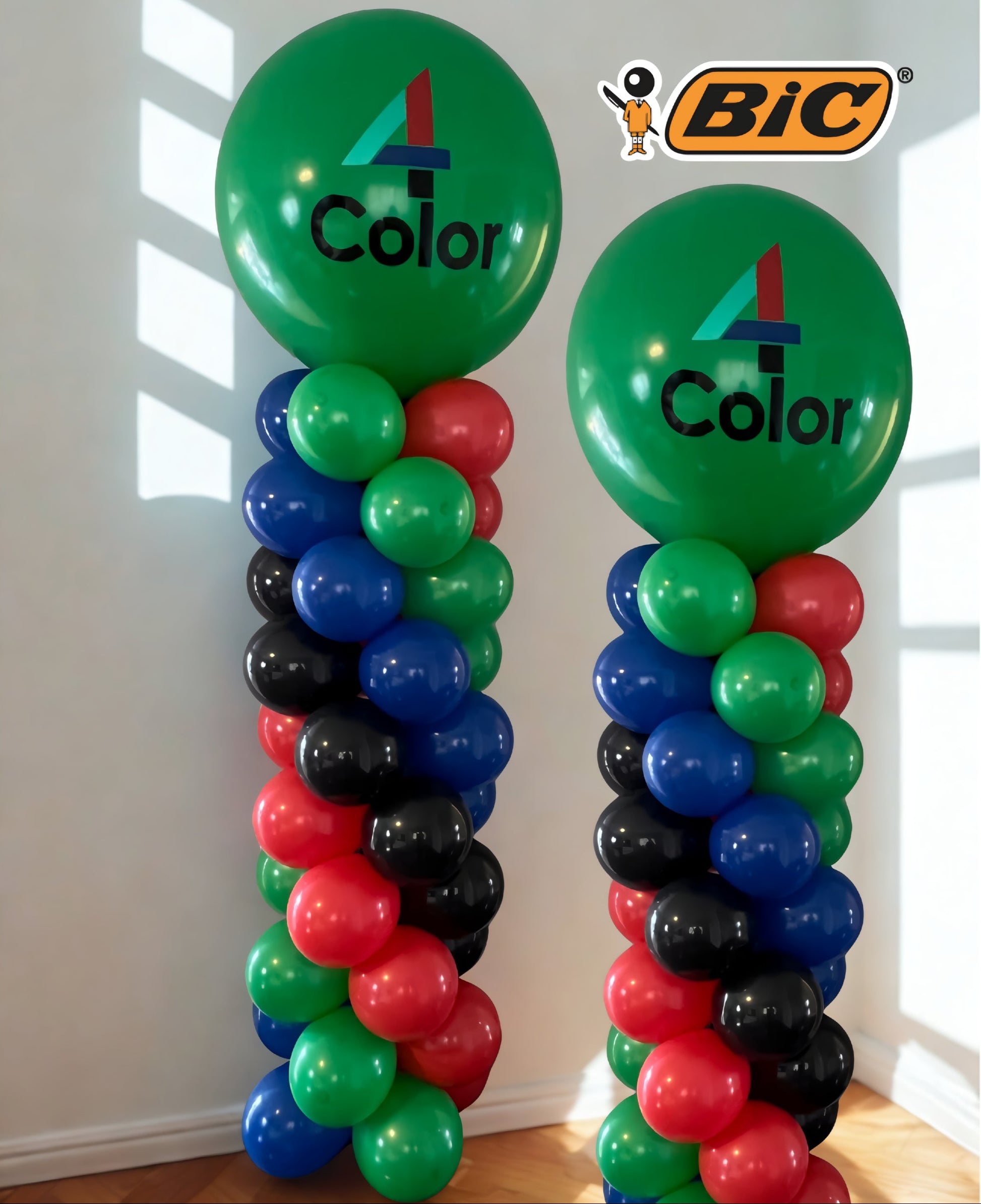 Branded corporate balloon towers in green, red, blue, and black with custom BIC 4 Color logo balloons