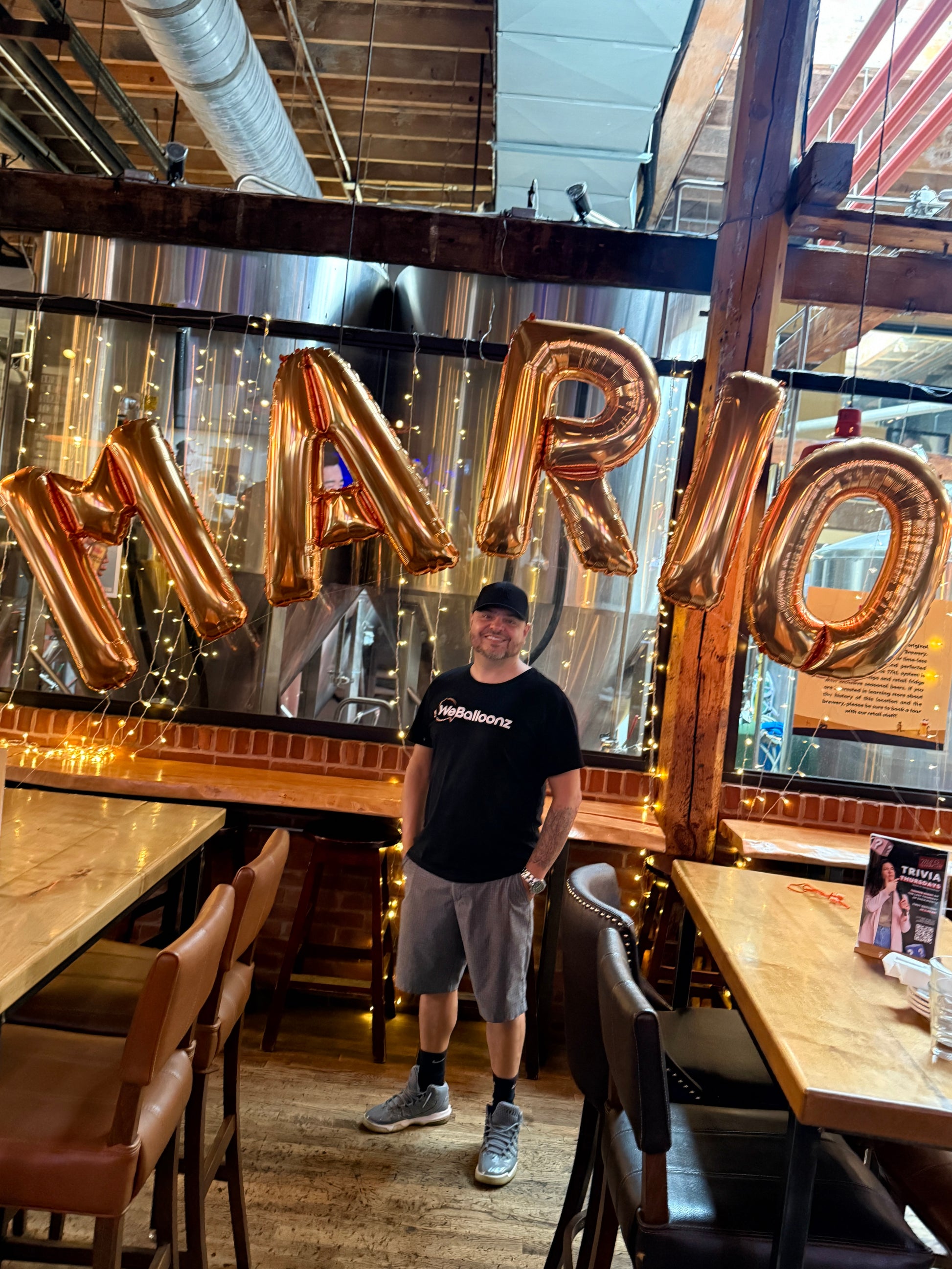 Custom 34 inch gold foil balloon letter arch spelling 'MARIO' for a luxury event installation in Vaughan by WeBalloonz.