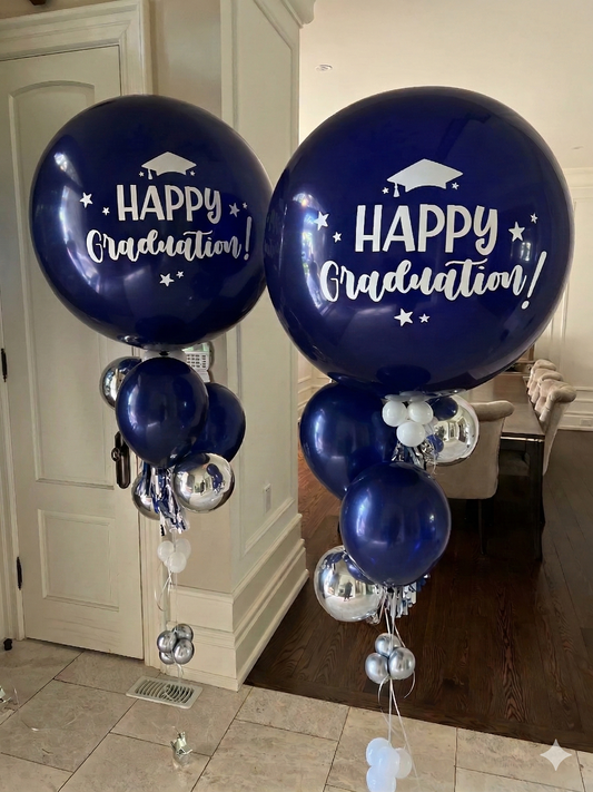 Two jumbo personalized navy and silver graduation helium balloon bouquets with custom 'Happy Graduation' messaging by WeBalloonz.
